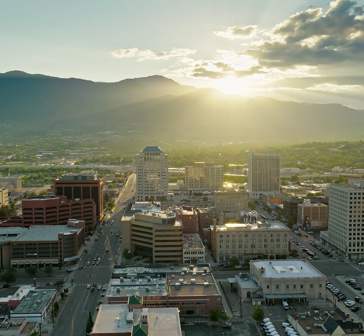 City skyline at sunset with mountains