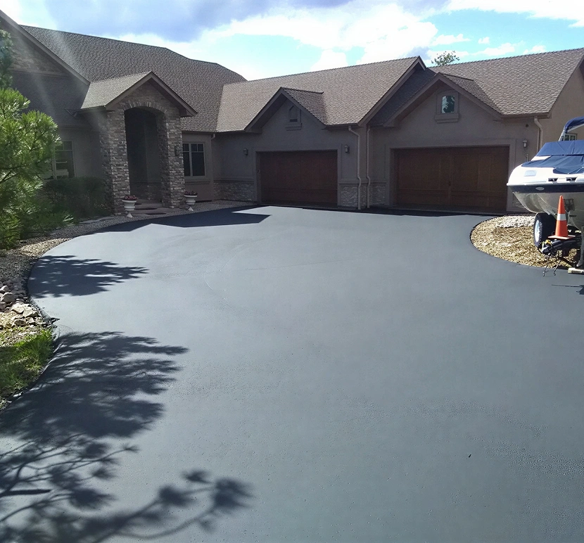 Newly paved driveway in front of house.