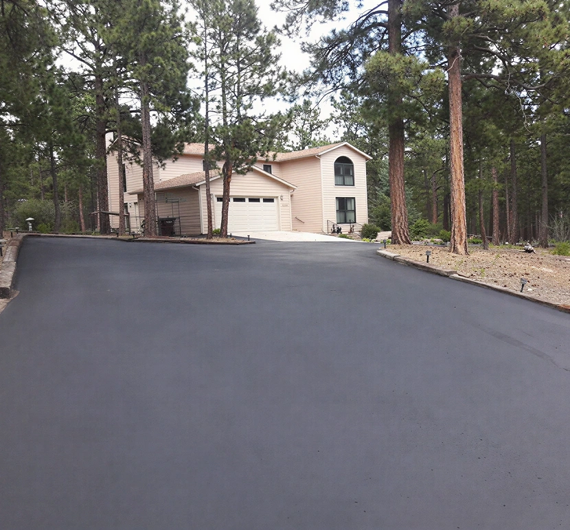 Suburban house with fresh asphalt driveway