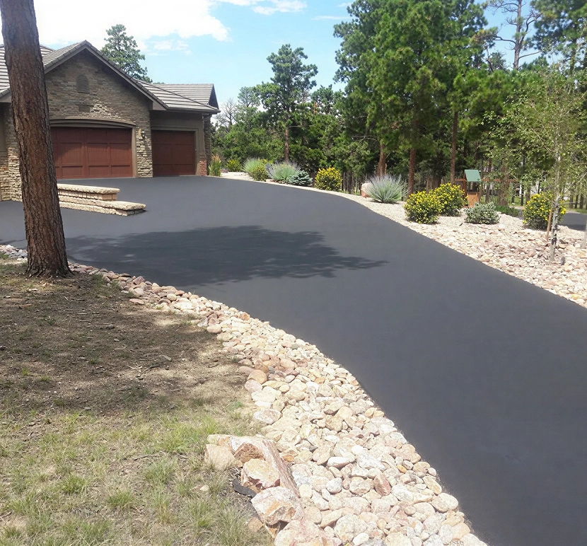 Asphalt driveway with surrounding rocks
